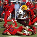 Arizona safety Chacho Ulloa (13) strips the ball from Arizona State running back Eno Benjamin (3) in the first half during an NCAA college football game, Saturday, Nov. 24, 2018, in Tucson, Ariz. (AP Photo/Rick Scuteri)