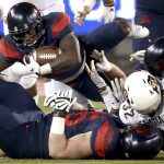 Arizona running back J.J. Taylor (21) throws himself over the pile at the line for an extra yard against Colorado during the first quarter of an NCAA college football game Friday, Nov. 2, 2018, in Tucson, Ariz. (Kelly Presnell/Arizona Daily Star via AP)