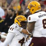 Arizona State defensive lineman Tyler Johnson (41) celebrates with Arizona State linebacker Merlin Robertson (8) after recovering a fumble in the second half during an NCAA college football game against Arizona, Saturday, Nov. 24, 2018, in Tucson, Ariz. (AP Photo/Rick Scuteri)