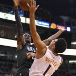 Brooklyn Nets guard Caris LeVert (22) pressures Phoenix Suns guard Devin Booker during the second half of an NBA basketball game Tuesday, Nov. 6, 2018, in Phoenix. The Nets won 104-82. (AP Photo/Rick Scuteri)