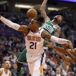 Boston Celtics guard Marcus Smart is fouled by Phoenix Suns forward Richaun Holmes (21) during the first half of an NBA basketball game Thursday, Nov. 8, 2018, in Phoenix. (AP Photo/Matt York)