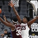 Mississippi State's Aric Holman (35) shoots around Arizona State's Romello White (23) during the first half of a NCAA college basketball game Monday, Nov. 19, 2018, in Las Vegas. (AP Photo/John Locher)