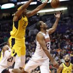 Phoenix Suns forward T.J. Warren (12) shoots under Indiana Pacers center Myles Turner (33) during the second half of an NBA basketball game, Tuesday, Nov. 27, 2018, in Phoenix. The Pacers won 109-104. (AP Photo/Matt York)