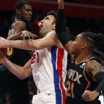 Detroit Pistons center Zaza Pachulia (27) is fouled as Phoenix Suns forward Richaun Holmes (21) and forward Josh Jackson (20) defend during the first half of an NBA basketball game, Sunday, Nov. 25, 2018, in Detroit. (AP Photo/Carlos Osorio)