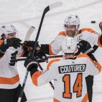 Philadelphia Flyers' Travis Konecny (11) Claude Giroux (28) congratulate Sean Couturier (14) after he scored against the Arizona Coyotes during the second period of an NHL hockey game Monday, Nov. 5, 2018, in Glendale, Ariz. (AP Photo/Darryl Webb)