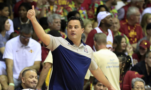 Arizona head coach Sean Miller signals to his team during the first half of an NCAA college basketb...