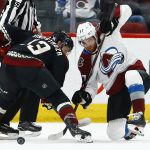 Arizona Coyotes center Vinnie Hinostroza, left, battles with Colorado Avalanche left wing J.T. Compher (37) during a face off during the first period of an NHL hockey game Friday, Nov. 23, 2018, in Glendale, Ariz. (AP Photo/Ross D. Franklin)