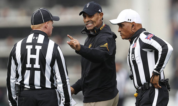Arizona State head coach Herm Edwards, center, confers with head linesman Bob Day, left, and refere...