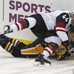 Arizona Coyotes' Kevin Connauton (44) falls on top of Pittsburgh Penguins' Jake Guentzel (59) during the first period of an NHL hockey game in Pittsburgh, Saturday, Nov. 10, 2018. (AP Photo/Gene J. Puskar)