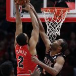Phoenix Suns forward T.J. Warren, right, blocks a shot by Chicago Bulls forward Jabari Parker during the first half of an NBA basketball game Wednesday, Nov. 21, 2018, in Chicago. (AP Photo/Nam Y. Huh)