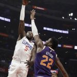 Los Angeles Clippers' Montrezl Harrell (5) shoots over Phoenix Suns' Deandre Ayton (22) during the first half of an NBA basketball game Wednesday, Nov. 28, 2018, in Los Angeles. (AP Photo/Marcio Jose Sanchez)