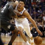 Phoenix Suns guard Devin Booker (1) is fouled by Brooklyn Nets guard Caris LeVert during the second half of an NBA basketball game Tuesday, Nov. 6, 2018, in Phoenix. The Nets won 104-82. (AP Photo/Rick Scuteri)