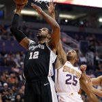 San Antonio Spurs forward LaMarcus Aldridge (12) shoots as Phoenix Suns forward Mikal Bridges (25) defends during the first half of an NBA basketball game, Wednesday, Nov. 14, 2018, in Phoenix. (AP Photo/Matt York)