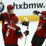 Arizona Coyotes center Derek Stepan (21) celebrates his goal against the Vegas Golden Knights with Coyotes defenseman Niklas Hjalmarsson (4) and defenseman Jakob Chychrun, left, during the first period of an NHL hockey game Wednesday, Nov. 21, 2018, in Glendale, Ariz. (AP Photo/Ross D. Franklin)