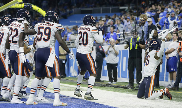 The Chicago Bears celebrate after cornerback Kyle Fuller intercepted a pass in the end zone intende...