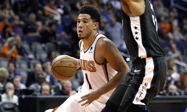 Phoenix Suns guard Devin Booker (1) drives by Brooklyn Nets center Jarrett Allen during the second ...
