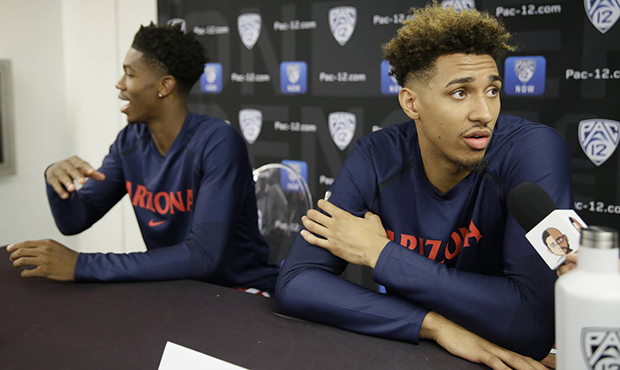 Arizona's Brandon Randolph, left, and Chase Jeter, right, take questions during the Pac-12 NCAA col...
