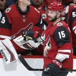 Arizona Coyotes center Brad Richardson (15) celebrates with teammates after scoring a goal against the Carolina Hurricanes during the first period of an NHL hockey game Friday, Nov. 2, 2018, in Glendale, Ariz. (AP Photo/Rick Scuteri)