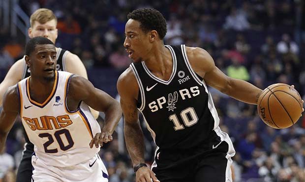San Antonio Spurs guard DeMar DeRozan (10) looks to pass as Phoenix Suns forward Josh Jackson (20) ...