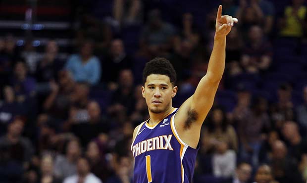 Phoenix Suns guard Devin Booker reacts in the second half during an NBA basketball game against the...