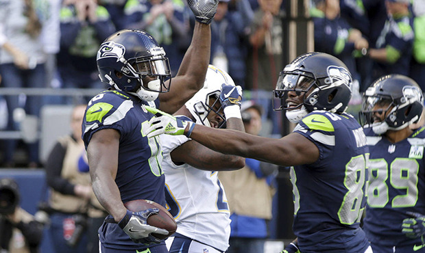Seattle Seahawks' Jaron Brown, left, celebrates his touchdown against the Los Angeles Chargers with...