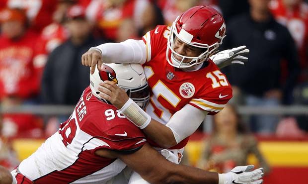 Kansas City Chiefs quarterback Patrick Mahomes (15) is hit by Arizona Cardinals defensive tackle Co...
