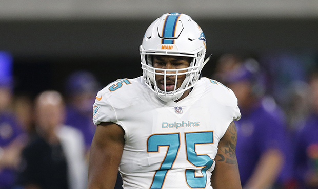 Miami Dolphins defensive end Cameron Malveaux stands on the field during the first half of an NFL p...