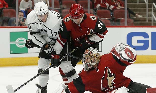 Arizona Coyotes goaltender Antti Raanta, right, makes a diving save on a shot as Los Angeles Kings ...