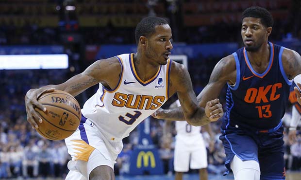Phoenix Suns forward Trevor Ariza (3) drives around Oklahoma City Thunder forward Paul George (13) ...