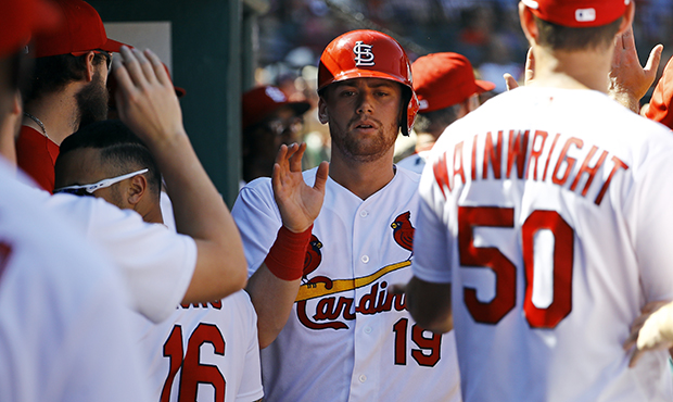 St. Louis Cardinals' Carson Kelly is congratulated by teammates after scoring during the eighth inn...
