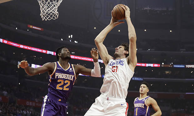 Los Angeles Clippers' Boban Marjanovic (51) grabs a rebound next to Phoenix Suns' Deandre Ayton (22...