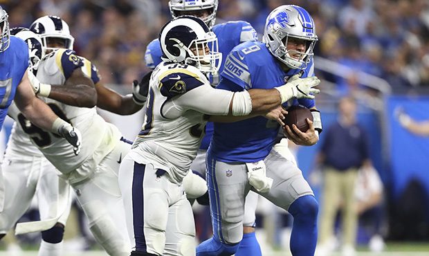 Detroit Lions quarterback Matthew Stafford (9) is tackled by Los Angeles Rams defensive tackle Aaro...