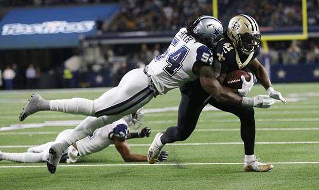 New Orleans Saints running back Alvin Kamara (41) is hit by Dallas Cowboys middle linebacker Jaylon...