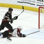 Arizona Coyotes center Brad Richardson (15) scores an empty net goal as Colorado Avalanche left wing Gabriel Landeskog (92) is unable to stop the puck during the third period of an NHL hockey game Saturday, Dec. 22, 2018, in Glendale, Ariz. The Coyotes defeated the Avalanche 6-4. (AP Photo/Ross D. Franklin)
