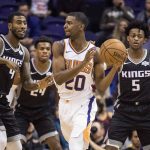 Surrounded by Sacramento Kings' Iman Shumpert (9), Buddy Hield (24) and De'Aaron Fox (5), Phoenix Suns' Josh Jackson (20) looks to pass during the first half of an NBA basketball game, Tuesday, Dec. 4, 2018, in Phoenix. (AP Photo/Darryl Webb)