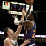Phoenix Suns center Deandre Ayton, right, shoots over Portland Trail Blazers forward Zach Collins, left, during the first half of an NBA basketball game in Portland, Ore., Thursday, Dec. 6, 2018. (AP Photo/Steve Dykes)