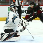 Arizona Coyotes center Nick Schmaltz (8) scores a goal against San Jose Sharks goaltender Aaron Dell, left, during the second period of an NHL hockey game, Saturday, Dec. 8, 2018, in Phoenix. (AP Photo/Ross D. Franklin)