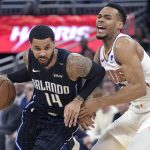Orlando Magic guard D.J. Augustin (14) drives to the basket in front of Phoenix Suns guard Elie Okobo, right, during the first half of an NBA basketball game Wednesday, Dec. 26, 2018, in Orlando, Fla. (AP Photo/Phelan M. Ebenhack)
