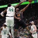 Phoenix Suns forward T.J. Warren (12) drives to the basket against Boston Celtics center Robert Williams (44) during the second half of a basketball game in Boston, Wednesday, Dec. 19, 2018. The Suns defeated the Celtics 111-103. (AP Photo/Charles Krupa)