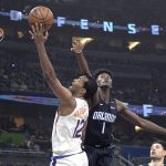 Phoenix Suns forward T.J. Warren (12) is fouled by Orlando Magic forward Jonathan Isaac (1) while going up for a shot during the first half of an NBA basketball game Wednesday, Dec. 26, 2018, in Orlando, Fla. (AP Photo/Phelan M. Ebenhack)