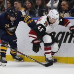Buffalo Sabres defenseman Lawrence Pilut (24) and Arizona Coyotes forward Josh Archibald (45) battle for the puck during the second period of an NHL hockey game, Thursday, Dec. 13, 2018, in Buffalo N.Y. (AP Photo/Jeffrey T. Barnes)