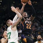 Phoenix Suns center Deandre Ayton (22) shoots over Boston Celtics forward Daniel Theis (27) during the second half of a basketball game in Boston, Wednesday, Dec. 19, 2018. Ayton scored 23 as the Suns defeated the Celtics 111-103. (AP Photo/Charles Krupa)
