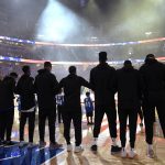Phoenix Suns players lock arms during the singing of the national anthem before an NBA basketball game against the Orlando Magic on Wednesday, Dec. 26, 2018, in Orlando, Fla. (AP Photo/Phelan M. Ebenhack)