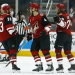 Arizona Coyotes right wing Mario Kempe (29) celebrates his goal against the New York Islanders with defenseman Alex Goligoski (33) and defenseman Niklas Hjalmarsson (4) during the first period of an NHL hockey game Tuesday, Dec. 18, 2018, in Glendale, Ariz. (AP Photo/Ross D. Franklin)