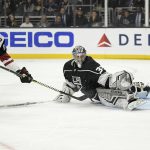 Los Angeles Kings goaltender Jonathan Quick, right, deflects a shot by Arizona Coyotes left wing Lawson Crouse during the first period of an NHL hockey game Thursday, Dec. 27, 2018, in Los Angeles. (AP Photo/Mark J. Terrill)