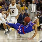 Kansas guard Devon Dotson (11) loses the ball in front of Arizona State guard Rob Edwards during the first half of an NCAA college basketball game Saturday, Dec. 22, 2018, in Tempe, Ariz. (AP Photo/Rick Scuteri)