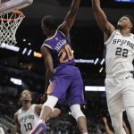 Phoenix Suns forward Josh Jackson (20) is blocked by San Antonio Spurs forward Rudy Gay (22) as he tries to score during the first half of an NBA basketball game, Tuesday, Dec. 11, 2018, in San Antonio. (AP Photo/Eric Gay)