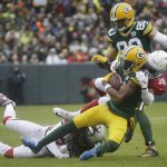 Green Bay Packers wide receiver Davante Adams is hit by Arizona Cardinals strong safety Budda Baker after making a catch during the first half of an NFL football game Sunday, Dec. 2, 2018, in Green Bay, Wis. (AP Photo/Mike Roemer)