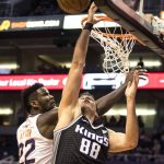 Sacramento Kings' Nemanja Bjelica (88) gets fouled by Phoenix Suns' Deandre Ayton (22) during the first half of an NBA basketball game, Tuesday, Dec. 4, 2018, in Phoenix. (AP Photo/Darryl Webb)