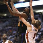 Phoenix Suns forward Josh Jackson shoots over Miami Heat forward Kelly Olynyk (9) during the second half during an NBA basketball game Friday, Dec. 7, 2018, in Phoenix. The Heat won 115-98. (AP Photo/Rick Scuteri)